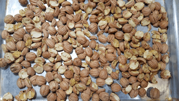 Roast nuts until papery husk sloughs off.