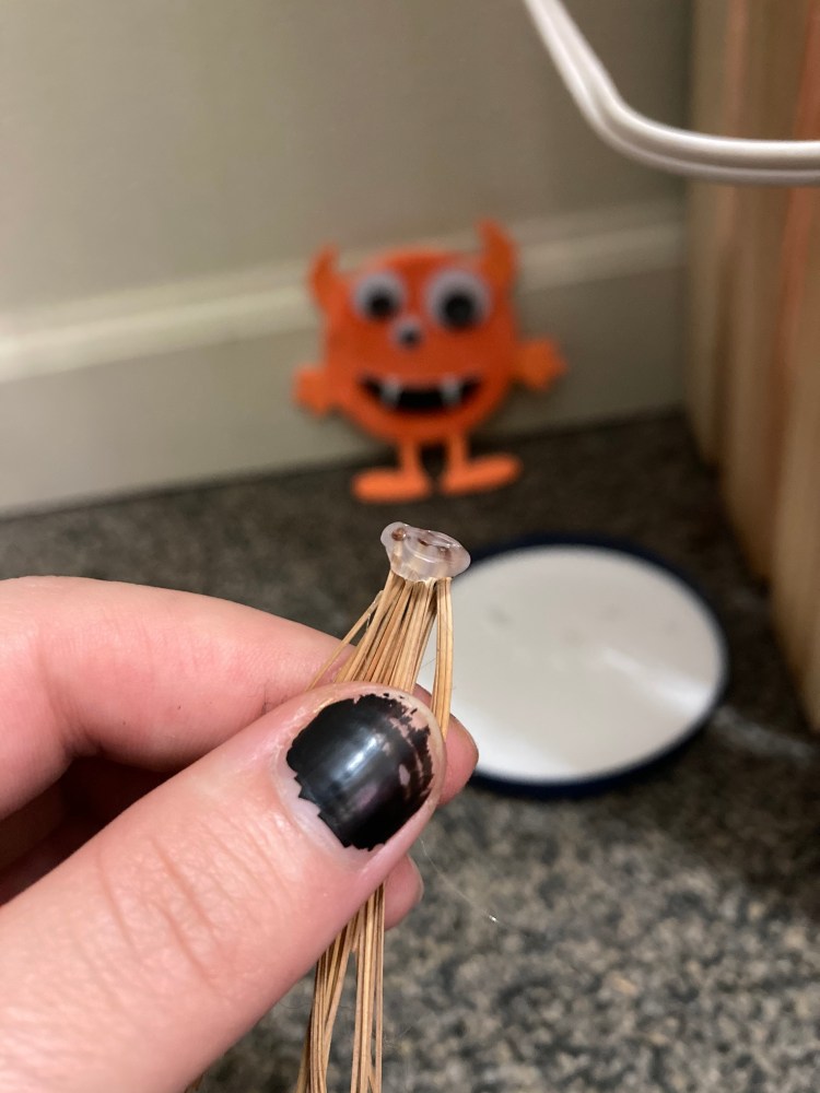 While holding the needled together at one end, you take the glue gun and create a ring of glue around the ends